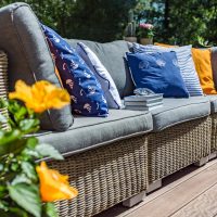 A patio couch with vibrant pillows