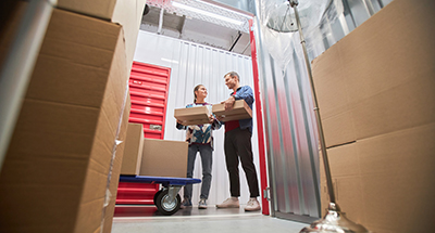 A couple moving into a storage unit